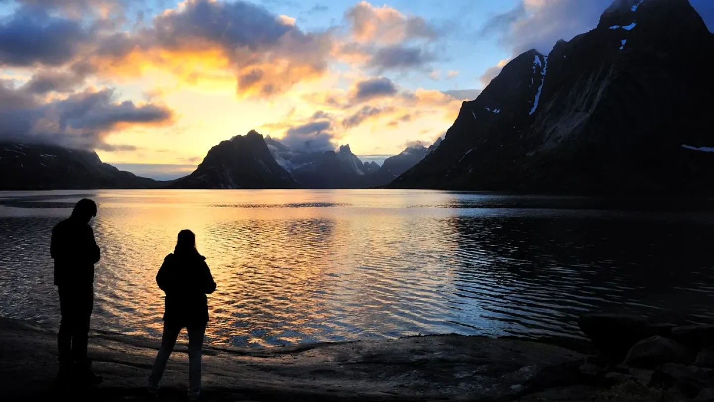 People enjoying the sunset on the beach along the National Scenic Route Lofoten