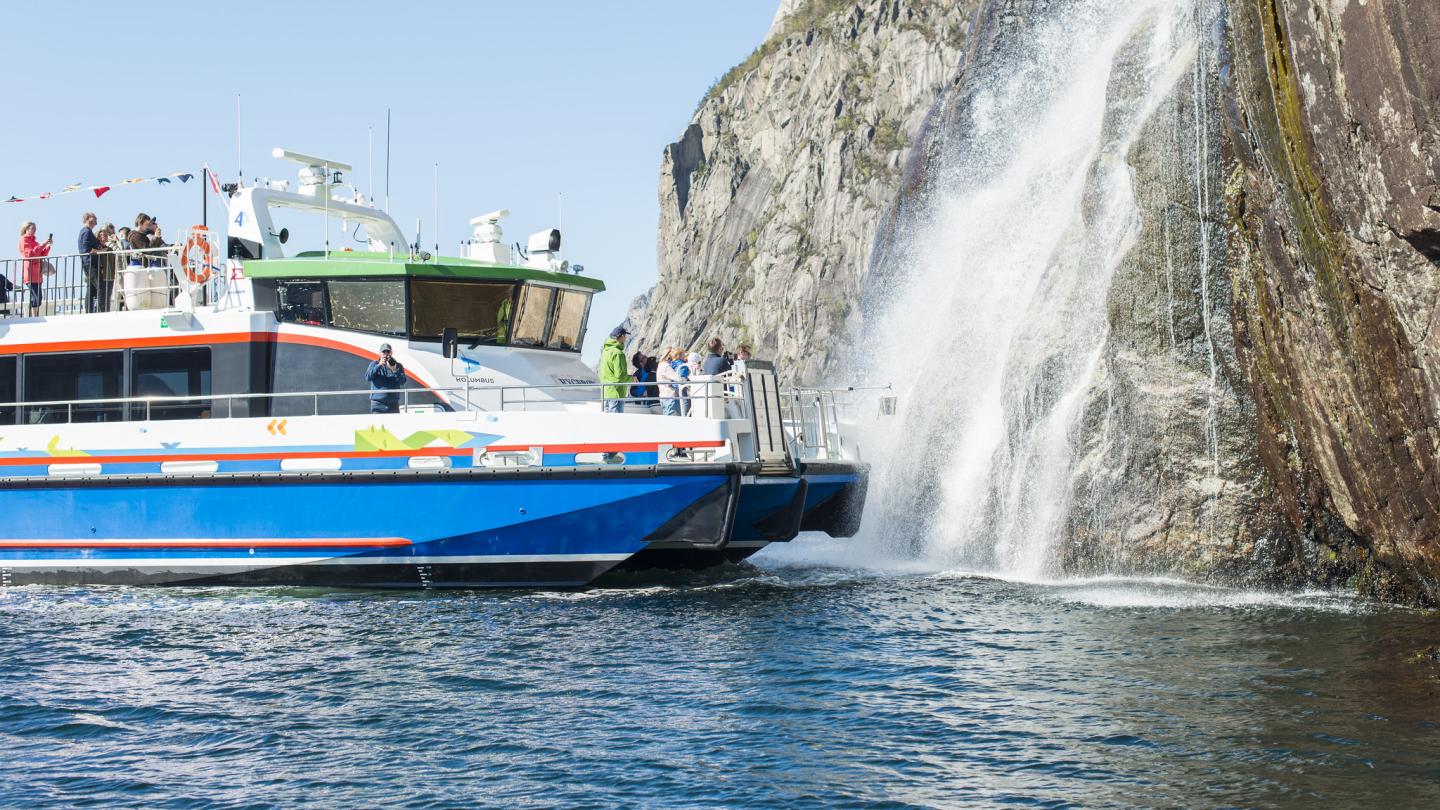 A ship from Rødne Fjord Cruise giving their guests a close encounter with a waterfall