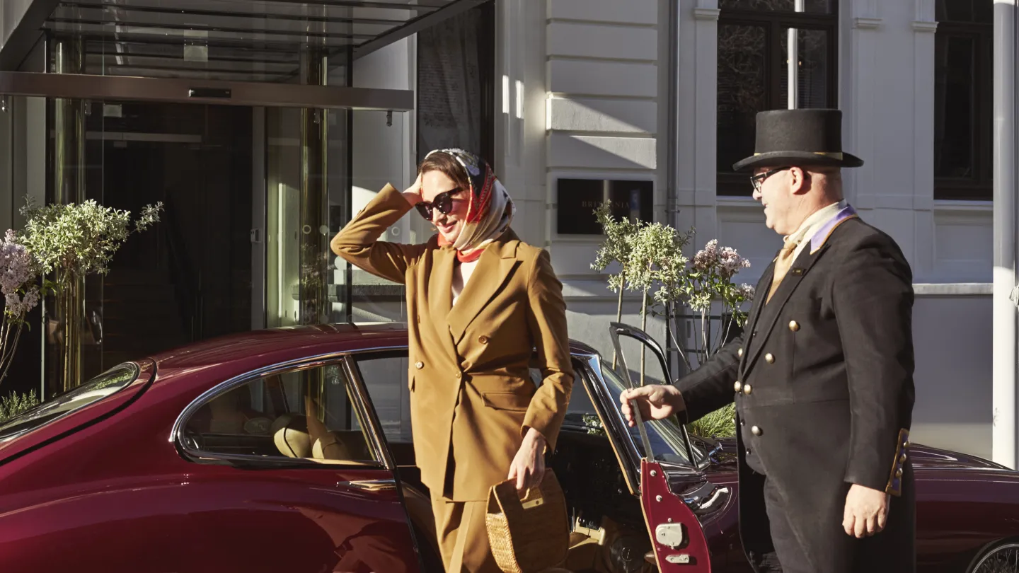 A guest exiting a car outside of Britannia Hotel