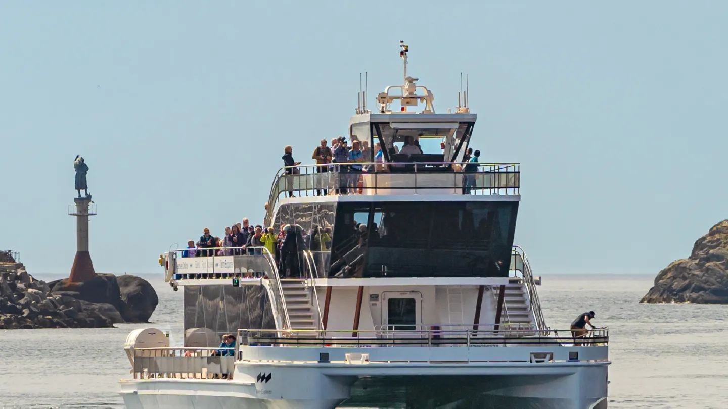 The iconic electric catamaran from Brim Explorer crossing the water with passengers onboard