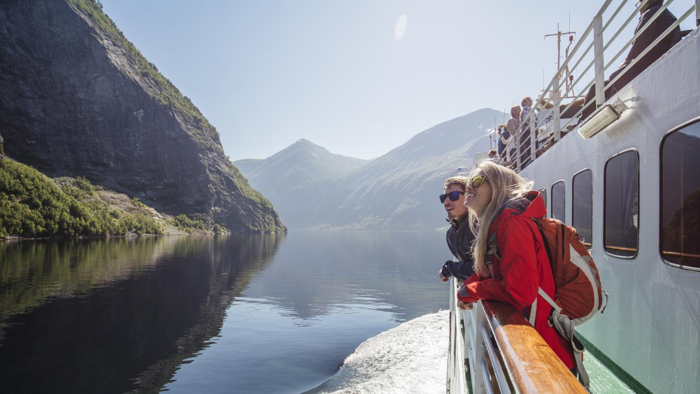 People enjoying the view from the fjord cruise in Geirangerfjorden