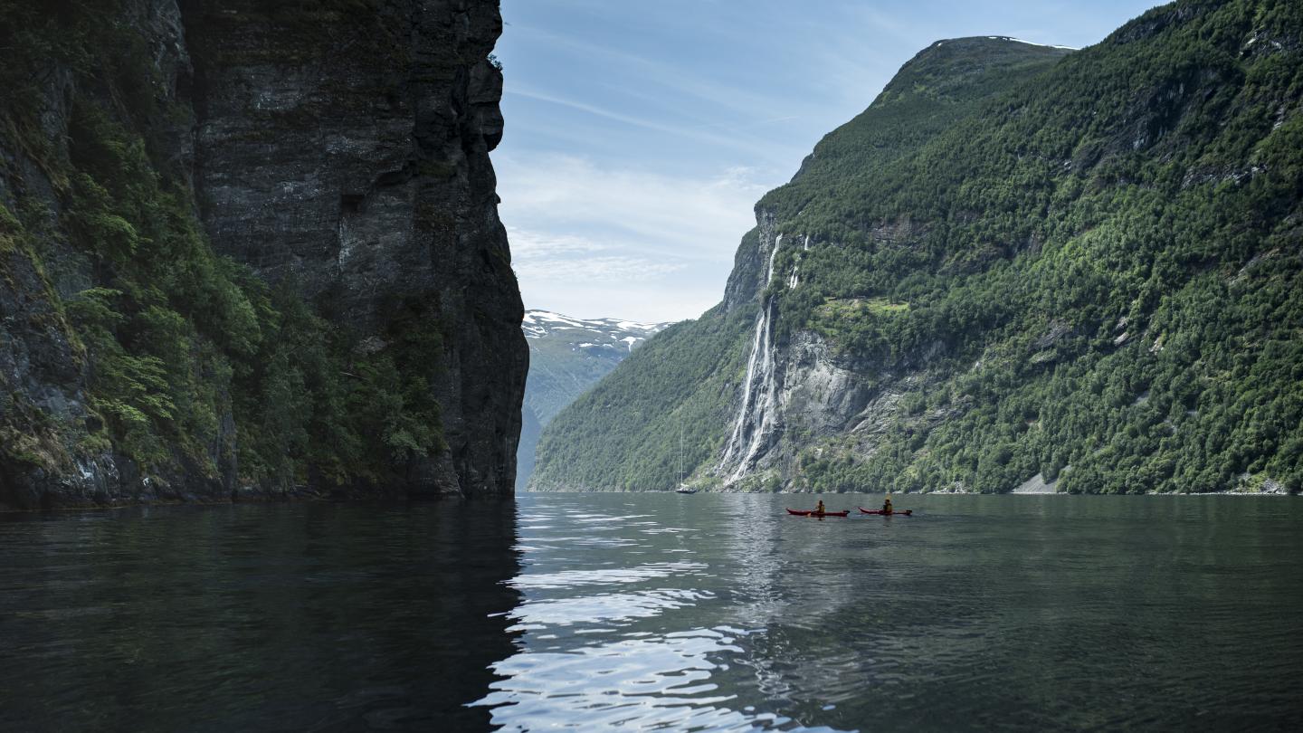 "The seven sisters", famous waterfall, in the distance in Geiranger fjord