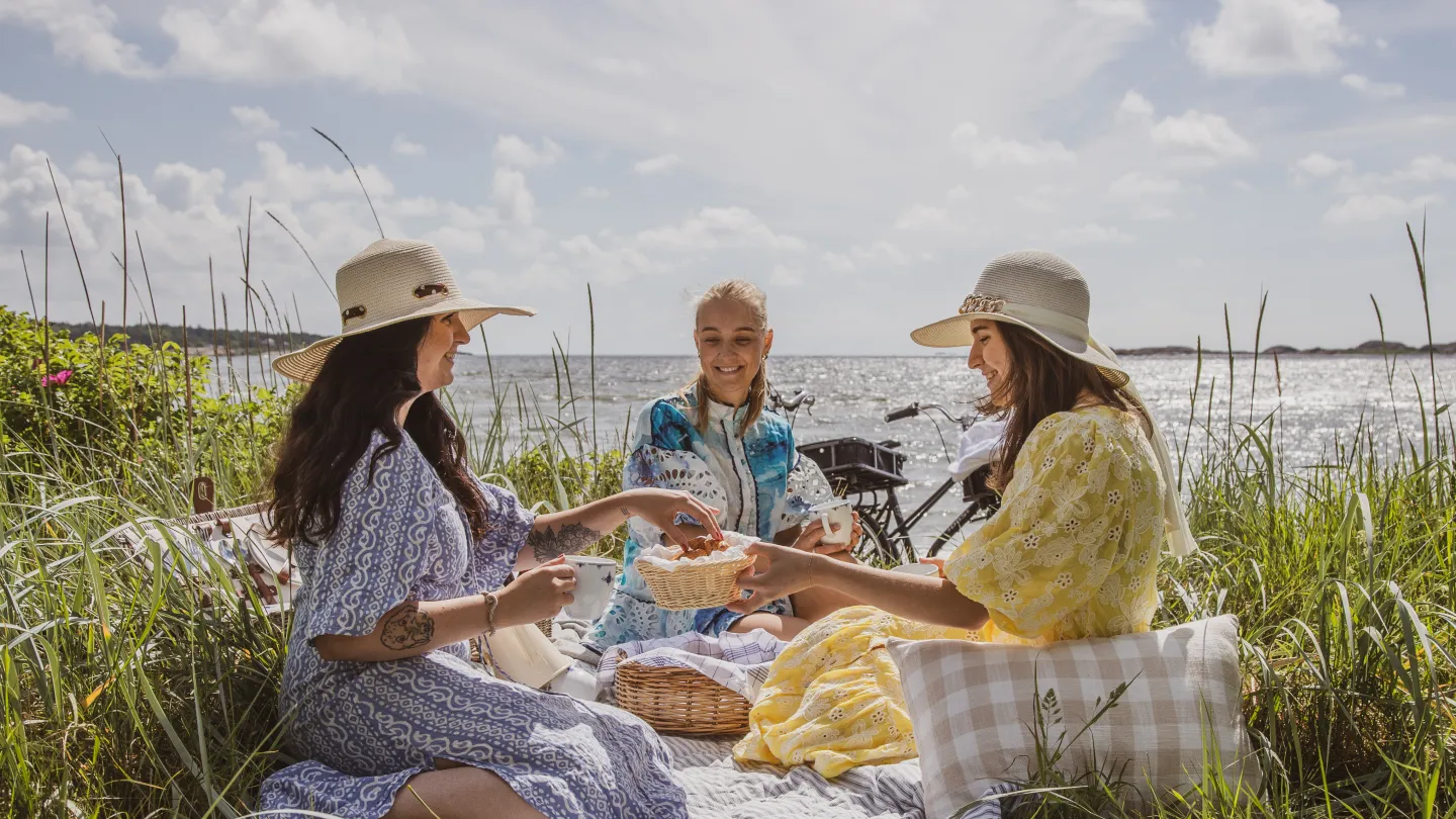 Three girls enjoying a picnic on the beach