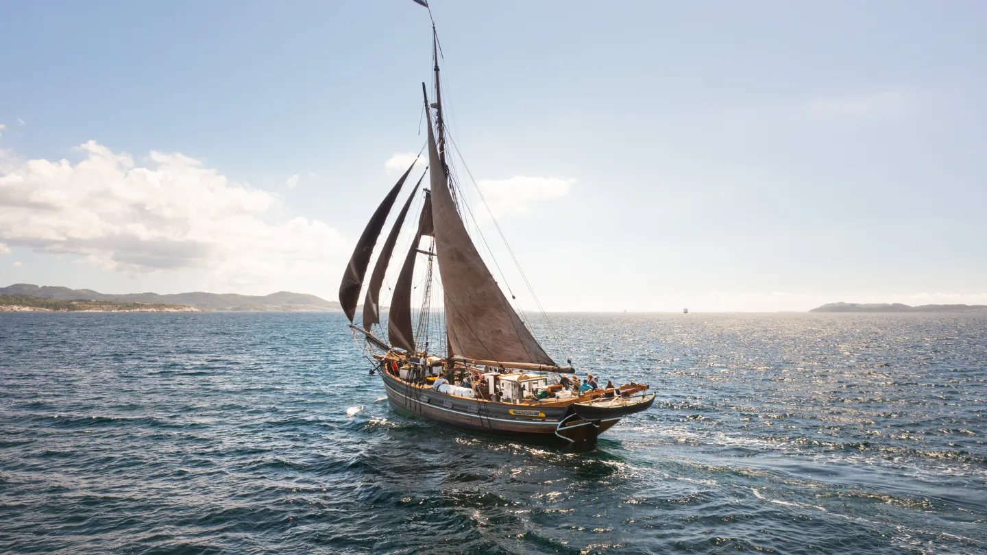 Mathilde sailing across the water. An old ship sailing on water, sunny.