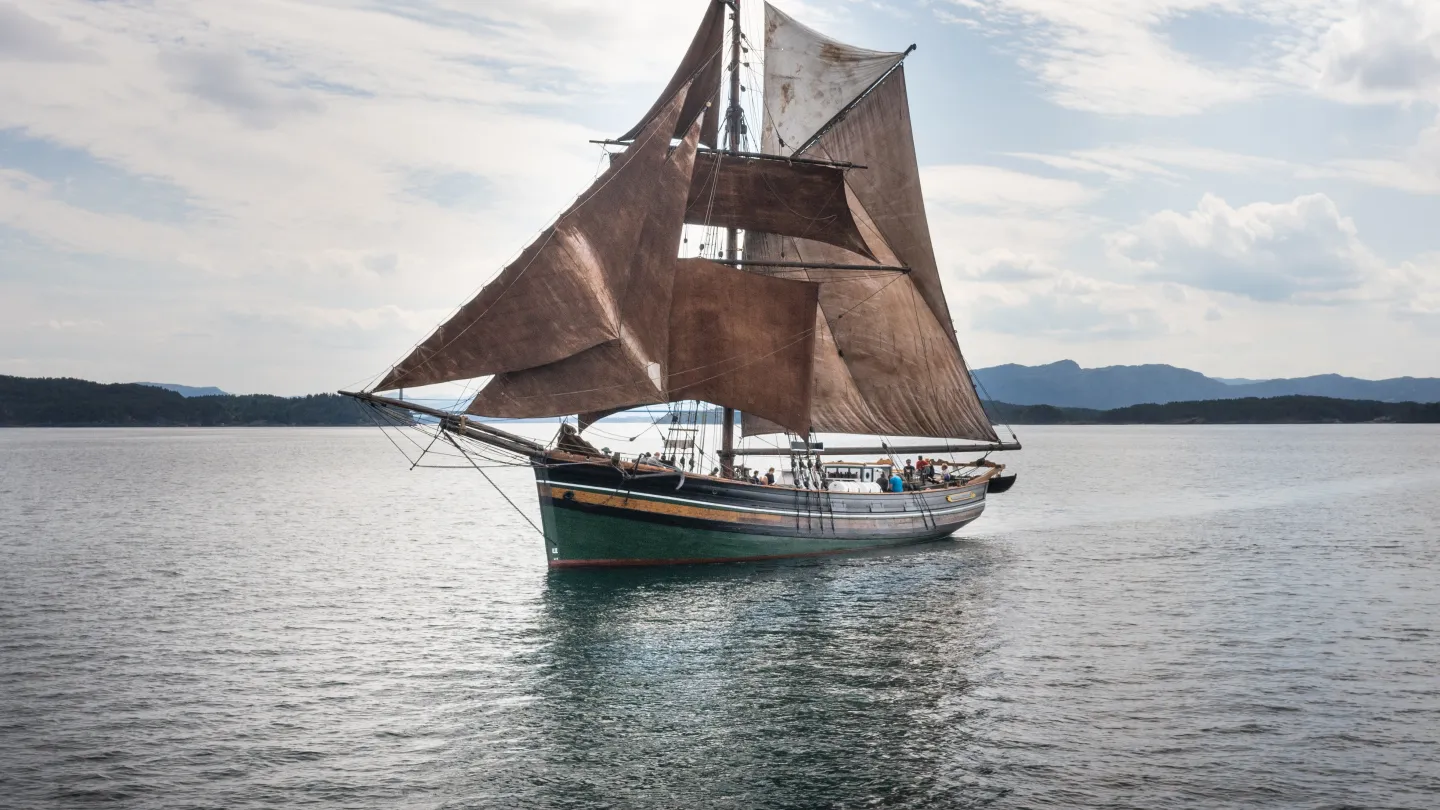 Mathilde sailing across the water. An old ship sailing on water, sunny.