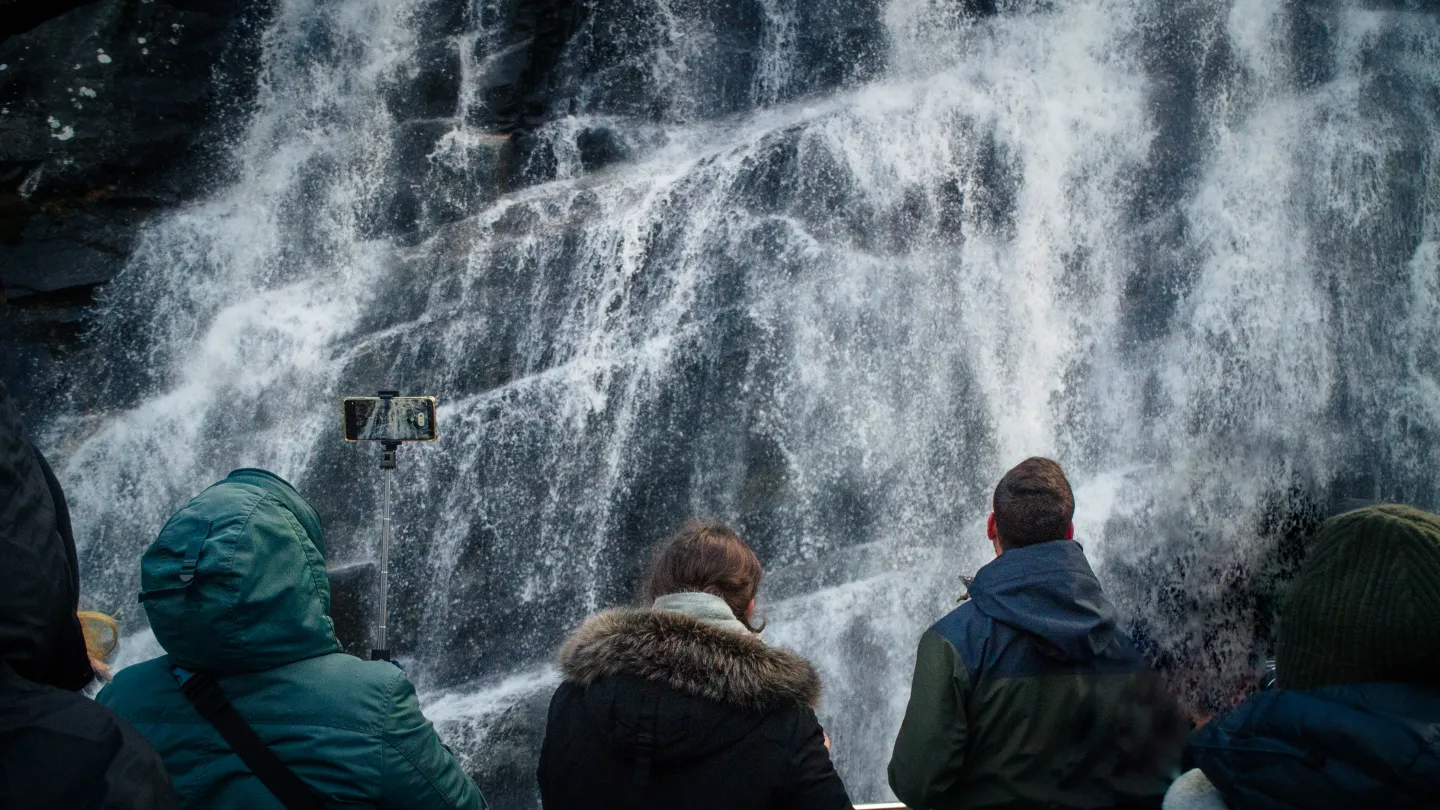 People experiencing a water fall just meters away