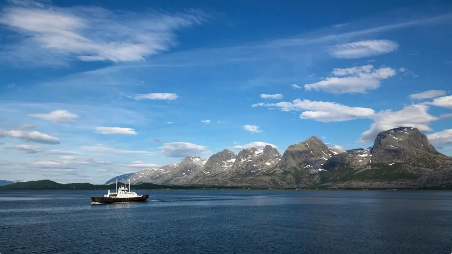 A ferry passing by the Seven Sisters mountain range