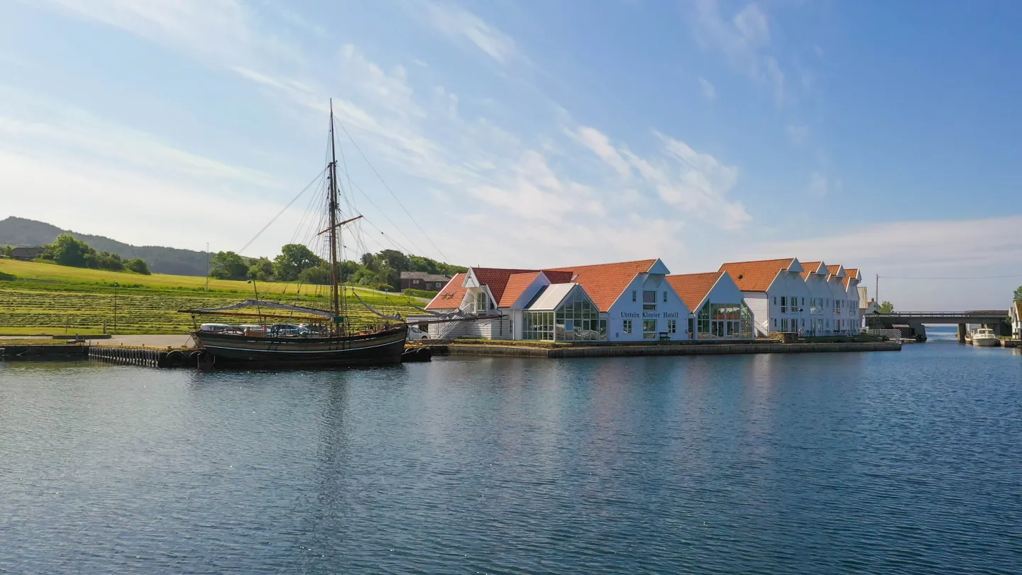 An exterior shot of Utstein Kloster Hotell from the seaside